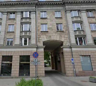 a large brick building with an archway in front of it at Lukiškės Central Apartment - Self Check-in and Parking Option in Vilnius