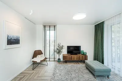 a living room with a television and a couch at Cozy Piliamiescio Apartament No 2 by URBAN RENT in Kaunas