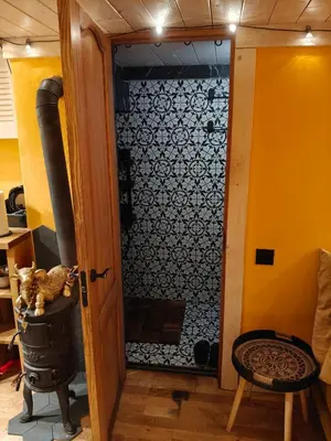 a glass door leading to a kitchen with a stove at Aušros Vartai in Vilnius