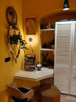 a room with a desk and a shelf with books at Aušros Vartai in Vilnius