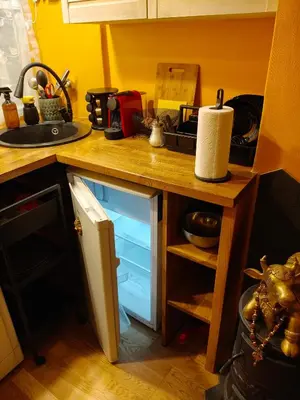 a kitchen with a counter with a sink and a drawer at Aušros Vartai in Vilnius