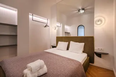 a bedroom with a bed with two towels on it at Kaunas Old Town Art Deco Apartments II in Kaunas