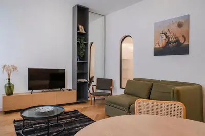a living room with a couch and a flat screen tv at Kaunas Old Town Art Deco Apartments II in Kaunas