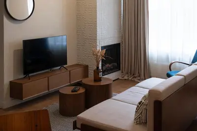 a living room with a flat screen tv and a couch at Kaunas Old Town Art Deco Apartments I in Kaunas