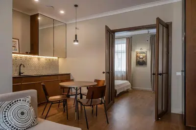 a kitchen and dining room with a table and chairs at Kaunas Old Town Art Deco Apartments I in Kaunas