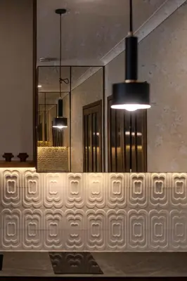 a bathroom with two chandeliers and a white wall at Kaunas Old Town Art Deco Apartments I in Kaunas