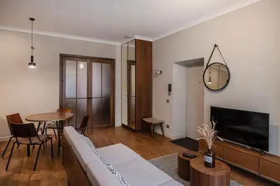 a living room with a couch and a table at Kaunas Old Town Art Deco Apartments I in Kaunas