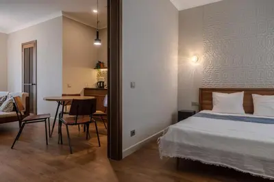 a bedroom with a bed and a table and a desk at Kaunas Old Town Art Deco Apartments I in Kaunas