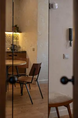 a dining room with a table and a chair at Kaunas Old Town Art Deco Apartments I in Kaunas