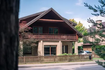 a house with a wooden fence in front of it at Domus Revado in Birštonas