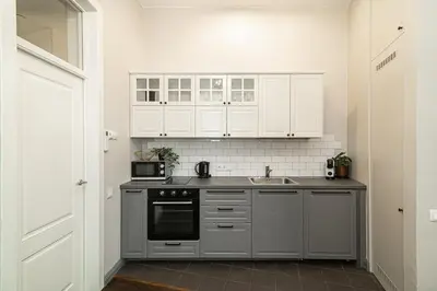 a kitchen with white cabinets and a sink at Old Town Apartments Senora Self Check-in and free parking in Vilnius