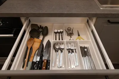 a drawer filled with utensils in a kitchen at Old Town Apartments Senora Self Check-in and free parking in Vilnius