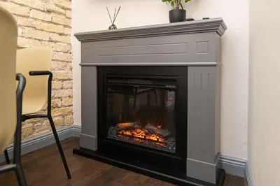 a fireplace with a fire in a room at Old Town Apartments Senora Self Check-in and free parking in Vilnius