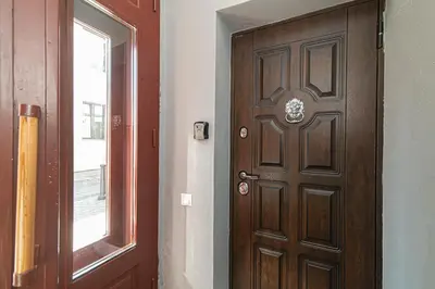 a wooden door in a room with a window at Old Town Apartments Senora Self Check-in and free parking in Vilnius
