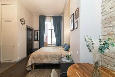 a bedroom with a bed and a table in a room at Old Town Apartments Senora Self Check-in and free parking in Vilnius