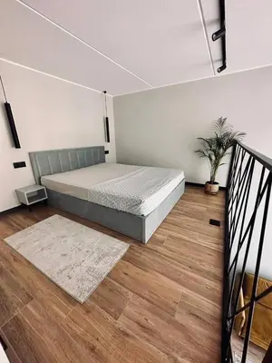 a bedroom with a large bed in a room at Sunny loft 3 x 24x7 x Close to old town in Vilnius
