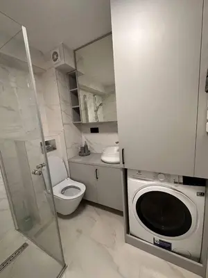 a bathroom with a washing machine and a toilet at Sunny loft 3 x 24x7 x Close to old town in Vilnius