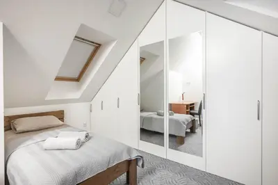 a bedroom with a bed and a mirror at Cathedral Square Apartment in Vilnius