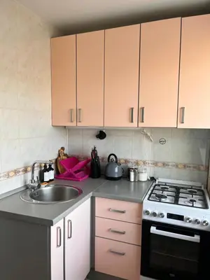 a kitchen with a sink and a stove and cabinets at Letastay in Trakai