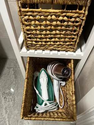 a basket with a hair dryer and other items in it at Letastay in Trakai