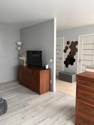 a living room with a flat screen tv on a dresser at Letastay in Trakai