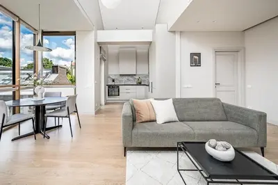 a living room with a couch and a table at Spacious 2 bedroom Luxury Apartment in Vilnius