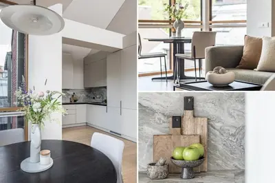 a kitchen and dining room with a table and chairs at Spacious 2 bedroom Luxury Apartment in Vilnius