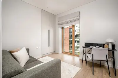 a living room with a couch and a desk at Spacious 2 bedroom Luxury Apartment in Vilnius