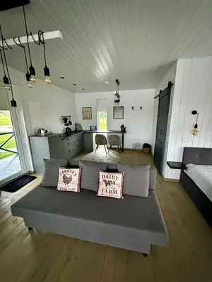 a living room with a couch with two pillows on it at DeerHouse in Kaliakiemiai