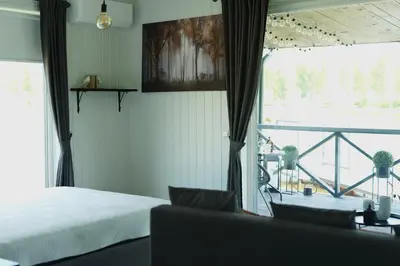 a bedroom with a bed and a view of a balcony at DeerHouse in Kaliakiemiai