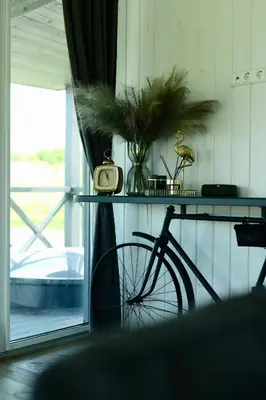 a bike parked next to a table with a clock on it at DeerHouse in Kaliakiemiai