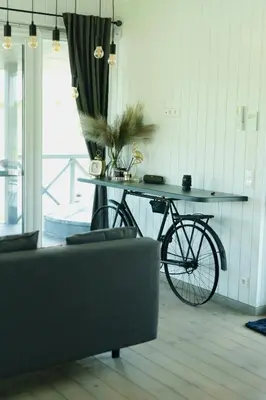 a bike parked next to a table in a room at DeerHouse in Kaliakiemiai