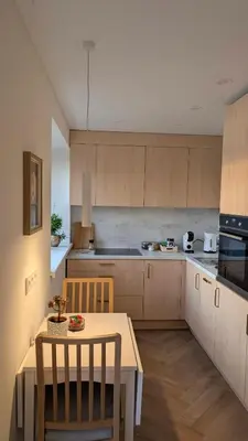 a kitchen with a table and two chairs and a table and a kitchen with at Kaunas River-View Retreat Free Parking in Kaunas