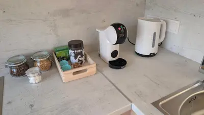 a kitchen counter with a blender and a coffee maker at Kaunas River-View Retreat Free Parking in Kaunas