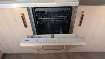 an empty dishwasher in a kitchen with a book at Kaunas River-View Retreat Free Parking in Kaunas