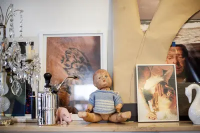 a teddy bear sitting on a table next to a picture at Old city gate in Vilnius