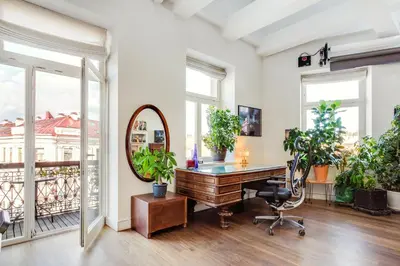an office with a mirror and a desk with plants at Old city gate in Vilnius