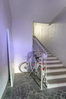 a bike is parked next to a staircase at Old city gate in Vilnius