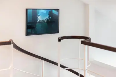 a picture hanging on a wall next to a staircase at Old city gate in Vilnius