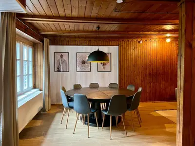 a dining room with a table and chairs at Villa Poilsinė in Balninkai