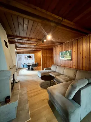 a living room with a couch and a table at Villa Poilsinė in Balninkai