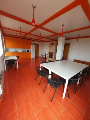 a large room with a white table and chairs at Vitkų sodyba in Pakopi