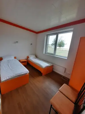 a small room with two beds and a window at Vitkų sodyba in Pakopi