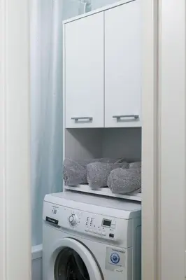 a washer and dryer in a kitchen with a cabinet at Gero laiko oazė in Visaginas