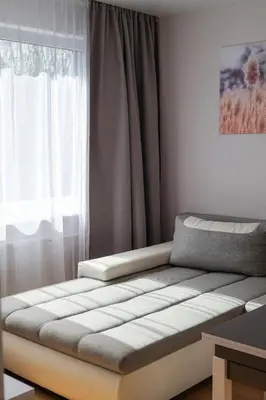 a bed in a room with a window at Gero laiko oazė in Visaginas