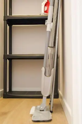 a mop standing on the floor next to a shelf at Gero laiko oazė in Visaginas
