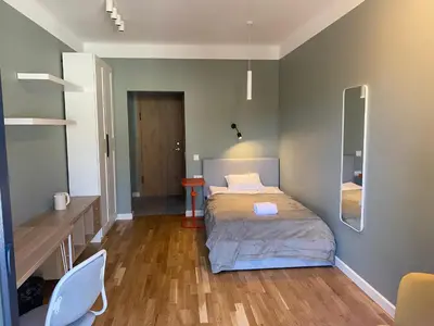a bedroom with a bed and a table and a mirror at 