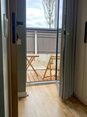 an open door to a patio with a table outside at 
