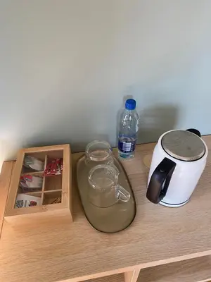 a wooden counter with a bottle of water and a blender at 