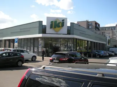 a dealership with cars parked in a parking lot at Guest room in Old Town in Vilnius